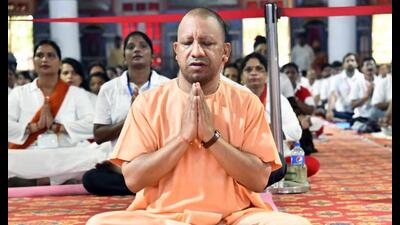 Chief minister Yogi Adityanath performs yoga to mark the 9th International Yoga Day, in Gorakhpur on Wednesday. (ANI Photo)