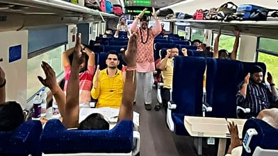 Passengers perform yoga inside moving Bhopal-New Delhi Vande Bharat Express train on International Day of Yoga (PTI) Passengers perform yoga inside moving Bhopal-New Delhi Vande Bharat Express train on International Day of Yoga (PTI)