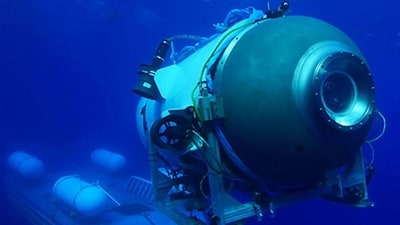 TOPSHOT - This undated image courtesy of OceanGate Expeditions, shows their Titan submersible launching from a platform. Rescue teams expanded their search underwater on June 20, 2023, as they raced against time to find a Titan deep-diving tourist submersible that went missing near the wreck of the Titanic with five people on board and limited oxygen. All communication was lost with the 21-foot (6.5-meter) Titan craft during a descent June 18 to the Titanic, which sits at a depth of crushing pressure more than two miles (nearly four kilometers) below the surface of the North Atlantic. (Photo by Handout / OceanGate Expeditions / AFP) / RESTRICTED TO EDITORIAL USE - MANDATORY CREDIT "AFP PHOTO / OceanGate Expeditions" - NO MARKETING NO ADVERTISING CAMPAIGNS - DISTRIBUTED AS A SERVICE TO CLIENTS (AFP) TOPSHOT - This undated image courtesy of OceanGate Expeditions, shows their Titan submersible launching from a platform. Rescue teams expanded their search underwater on June 20, 2023, as they raced against time to find a Titan deep-diving tourist submersible that went missing near the wreck of the Titanic with five people on board and limited oxygen. All communication was lost with the 21-foot (6.5-meter) Titan craft during a descent June 18 to the Titanic, which sits at a depth of crushing pressure more than two miles (nearly four kilometers) below the surface of the North Atlantic. (Photo by Handout / OceanGate Expeditions / AFP) / RESTRICTED TO EDITORIAL USE - MANDATORY CREDIT "AFP PHOTO / OceanGate Expeditions" - NO MARKETING NO ADVERTISING CAMPAIGNS - DISTRIBUTED AS A SERVICE TO CLIENTS (AFP)