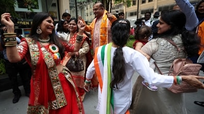 PM Modi in US: Indian community people cheer out and dance ahead the arrival of prime minister Narendra Modi, outside the Lotte hotel in New York City.&nbsp; (Reuters)