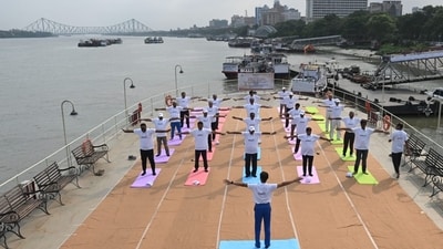 Port Trust officials participate in an event on 9th International Yoga Day on-board P S Bhopal against backdrop of iconic Howrah Bridge in Kolkata. (Hindustan Times/ Samir Jana) Port Trust officials participate in an event on 9th International Yoga Day on-board P S Bhopal against backdrop of iconic Howrah Bridge in Kolkata. (Hindustan Times/ Samir Jana)