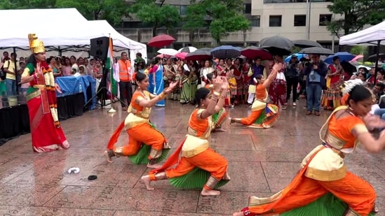 Indian community artists dance as they wait for PM Modi's arrival outside a hotel in Washington DC.(PTI)