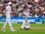 England's Ben Stokes reacts as Stuart Broad looks on 