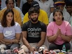 FILE PHOTO: Indian wrestlers Vinesh Phogat, Bajrang Punia, and Sakshi Malik address a news conference.