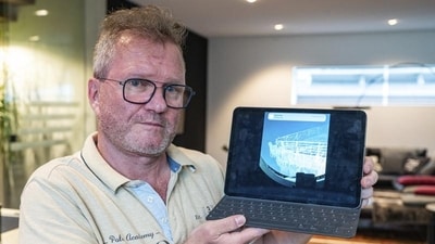 Arthur Loibl, one of the submersible company Oceangate's first customers, holds up a photo of the Titanic, in Straubing, Germany, Wednesday June 21, 2023. (AP) Arthur Loibl, one of the submersible company Oceangate's first customers, holds up a photo of the Titanic, in Straubing, Germany, Wednesday June 21, 2023. (AP)