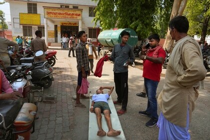 An elderly person suffering from heat-related ailment lies on a stretcher waiting to get admitted outside the overcrowded government district hospital in Ballia, UP, on June 19. (AP) An elderly person suffering from heat-related ailment lies on a stretcher waiting to get admitted outside the overcrowded government district hospital in Ballia, UP, on June 19. (AP)