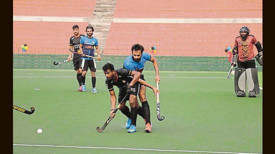 A match underway at Sector 42 Hockey Stadium on Thursday. (HT Photo)