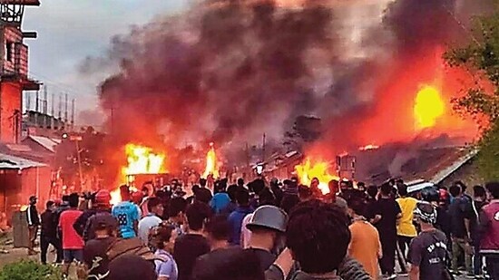 People at the site of fire in Manipur. (PTI)