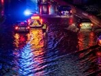 Vehicles drive through a flooded section of the A59 highway as heavy rain falls in Duisburg, Germany. Vehicles drive through a flooded section of the A59 highway as heavy rain falls in Duisburg, Germany.