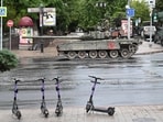 Fighters of Wagner private mercenary group are seen atop of a tank in a street near the headquarters of the Southern Military District in the city of Rostov-on-Don,