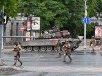Fighters of Wagner private mercenary group cross a street as they get deployed near the headquarters of the Southern Military District in the city of Rostov-on-Don, Russia, June 24, 2023. REUTERS/Stringer     TPX IMAGES OF THE DAY