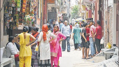 Locals gather around the residence of the 20-year-old victim, Rahul, at Brij Puri in New Delhi on Saturday. (Sanchit Khanna/HT PHOTO)