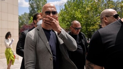 Andrew Tate gestures as he leaves the Bucharest Tribunal, along with his brother Tristan, right, after the first hearing in their trial, meant to establish if they will remain under house arrest, in Bucharest, Romania, Wednesday, June 21, 2023. Romanian prosecutors charged on Tuesday, June 20, 2023, the Tate brothers and two other suspects with human trafficking, rape and organizing a criminal group for the sexual exploitation of women. (AP Photo/Alexandru Dobre) (AP) Andrew Tate gestures as he leaves the Bucharest Tribunal, along with his brother Tristan, right, after the first hearing in their trial, meant to establish if they will remain under house arrest, in Bucharest, Romania, Wednesday, June 21, 2023. Romanian prosecutors charged on Tuesday, June 20, 2023, the Tate brothers and two other suspects with human trafficking, rape and organizing a criminal group for the sexual exploitation of women. (AP Photo/Alexandru Dobre) (AP)