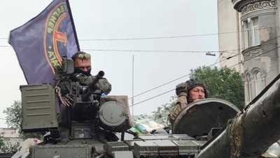 Servicemen sit in a tank with a flag of the Wagner Group military company, as they guard an area at the HQ of the Southern Military District in a street in Rostov-on-Don, Russia. (AP) Servicemen sit in a tank with a flag of the Wagner Group military company, as they guard an area at the HQ of the Southern Military District in a street in Rostov-on-Don, Russia. (AP)