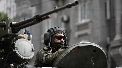 A fighter of Wagner private mercenary group is seen atop of an armoured vehicle in a street near the headquarters of the Southern Military District in the city of Rostov-on-Don, Russia, June 24, 2023. REUTERS/Stringer