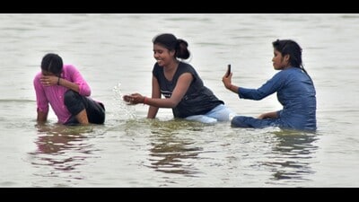 Youngsters cool down in Sangam in Prayagraj on Saturday (HT)