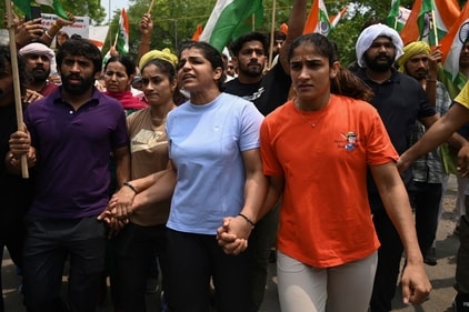 Wrestlers Vinesh Phogat, Bajrang Punia and Sakshi Malik during a protest. (AFP) Wrestlers Vinesh Phogat, Bajrang Punia and Sakshi Malik during a protest. (AFP)