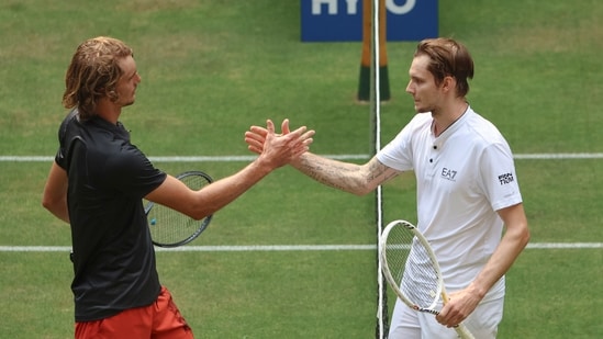 Kazakhstan's Alexander Bublik, right, shakes hands with Germany's Alexander Zverev after winning their semifinal match at the German Tennis Open (AP)