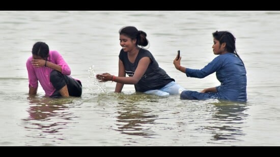 Youngsters cool down in Sangam in Prayagraj on Saturday (HT)