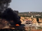 A plume of smoke rises from a building following a reported Russian air strike on Syria's northwestern rebel-held Idlib province.
