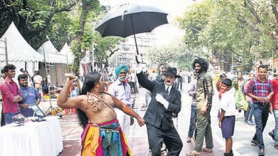 Mumbai, India – November 19, 2017: A man artists dressed as Charlie Chaplin take photo with family at Talent street art festival at Kala Ghoda, in Mumbai, India, on Sunday, Nov 19, 2017. (Photo by Bhushan Koyande/HT) Mumbai, India – November 19, 2017: A man artists dressed as Charlie Chaplin take photo with family at Talent street art festival at Kala Ghoda, in Mumbai, India, on Sunday, Nov 19, 2017. (Photo by Bhushan Koyande/HT)