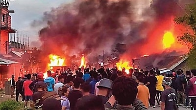 People at the site of fire in Manipur. (PTI) People at the site of fire in Manipur. (PTI)