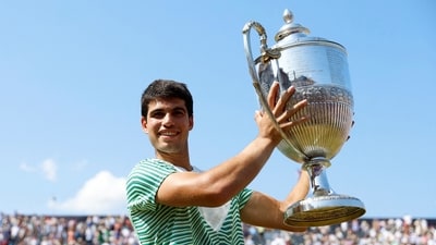 Spain's Carlos Alcaraz celebrates with the trophy after winning his final match against Australia's Alex de Minaur (Action Images via Reuters)