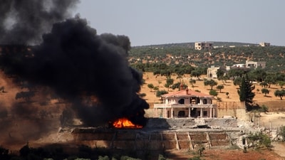 A plume of smoke rises from a building following a reported Russian air strike on Syria's northwestern rebel-held Idlib province. (AFP) A plume of smoke rises from a building following a reported Russian air strike on Syria's northwestern rebel-held Idlib province. (AFP)