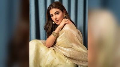 Her saree showcases a magnificent blend of organza fabric adorned with intricate hand embroidery throughout, complemented by a striking heavy embroidered golden border. She paired it with a stylish sleeveless printed blouse, completing the ensemble with finesse. (Instagram/@kajalaggarwalofficial)