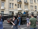 Members of Wagner group sit atop of a tank in a street in the city of Rostov-on-Don, on June 24.