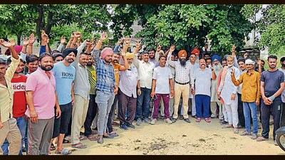 Dhandari Khurd residents stage a protest in Ludhiana . The residents said that the site adjoins the playground used to host the village panchayat ghar and is located in front of the cremation ground. (HT PHOTO)