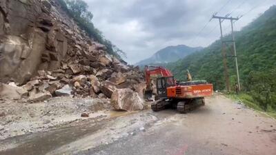 Heavy machinery being used to clear the blocked Chandigarh-Manali highway following a landslide triggered by continuous rain in Mandi district of Himachal Pradesh on Monday. (PTI Photo) Heavy machinery being used to clear the blocked Chandigarh-Manali highway following a landslide triggered by continuous rain in Mandi district of Himachal Pradesh on Monday. (PTI Photo)