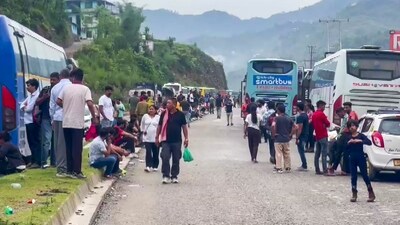 Commuters wait for the clearing of blocked Chandigarh-Manali highway following a landslide triggered by continuous rain in Himachal Pradesh (PTI) Commuters wait for the clearing of blocked Chandigarh-Manali highway following a landslide triggered by continuous rain in Himachal Pradesh (PTI)