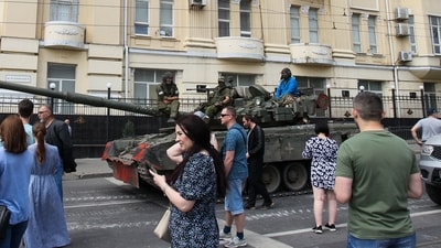 Members of Wagner group sit atop of a tank in a street in the city of Rostov-on-Don, on June 24. (AFP) Members of Wagner group sit atop of a tank in a street in the city of Rostov-on-Don, on June 24. (AFP)
