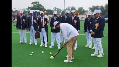 Union minister for youth affairs and sports and information and broadcasting Anurag Thakur takes the ceremonial first shot on the new astro turf at BSF headquarters in Jalandhar on Monday.