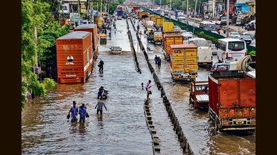 Vehicles move through waterlogged Delhi-Gurugram Expressway and its service road after heavy rainfall during the onset of monsoon in Gurugram on Monday. (PTI) Vehicles move through waterlogged Delhi-Gurugram Expressway and its service road after heavy rainfall during the onset of monsoon in Gurugram on Monday. (PTI)