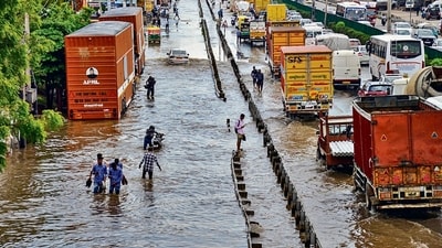 Vehicles move through waterlogged Delhi-Gurugram Expressway and its service road after heavy rainfall during the onset of monsoon in Gurugram on Monday. (PTI) Vehicles move through waterlogged Delhi-Gurugram Expressway and its service road after heavy rainfall during the onset of monsoon in Gurugram on Monday. (PTI)