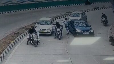 Four men on two motorcycles robbed a cab’s passengers at gunpoint on Sunday.