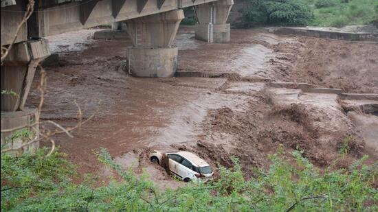 A woman swept away along with car in Ghaggar in Panchkula on Sunday. (Sant Arora/HT)