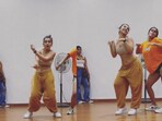 Woman dances to Move Your Body.