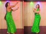 Saree-clad woman dancing to Genda Phool. Saree-clad woman dancing to Genda Phool.