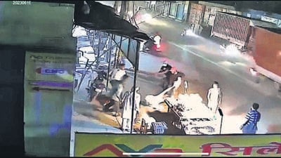 A videograb shows the elderly man being dragged on the road as the two robbers try to snatch the bag. (HT Photo)