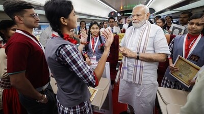Ahead of the flagging-off ceremony, PM Modi interacted with crew members of the train and some children onboard the Vande Bharat train at Rani Kamlapati railway station. (ANI/PIB) Ahead of the flagging-off ceremony, PM Modi interacted with crew members of the train and some children onboard the Vande Bharat train at Rani Kamlapati railway station. (ANI/PIB)