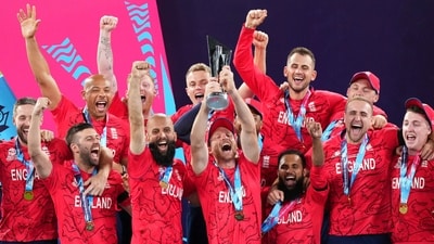 England's Jos Buttler holds aloft the trophy as they celebrate winning the T20 World Cup (AAP Image via REUTERS)