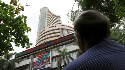 Sensex, Nifty today: A man looks at a screen across a road displaying the Sensex on the facade of the Bombay Stock Exchange (BSE) building in Mumbai, India. (File image) (REUTERS)