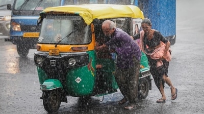 A couple push their auto rickshaw during heavy rains in Ahmedabad, Gujarat. (Reuters) A couple push their auto rickshaw during heavy rains in Ahmedabad, Gujarat. (Reuters)