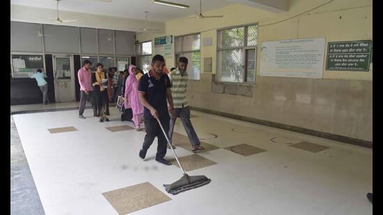 Civil hospital employees cleaning premises in Ludhiana (HT PHOTO)
