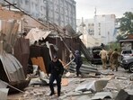 A police officer and a rescue worker walk in front of a restaurant RIA Pizza destroyed by a Russian attack in Kramatorsk, Ukraine, Tuesday, June 27. A police officer and a rescue worker walk in front of a restaurant RIA Pizza destroyed by a Russian attack in Kramatorsk, Ukraine, Tuesday, June 27.