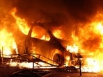 A vehicle burns, destroyed by protesters in Nanterre, west of Paris, on June 27, 2023, after French police killed a teenager who refused to stop for a traffic check in the city. (AFP)