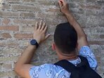 Tourist scribbles names on the Colosseum Tourist scribbles names on the Colosseum